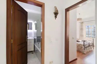 a hallway with a door leading to a bathroom at Golden Rana Apartment in Albufeira
