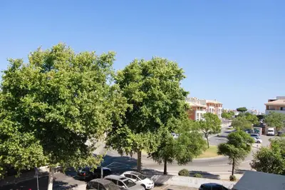 a view of a parking lot with trees and cars at Golden Rana Apartment in Albufeira