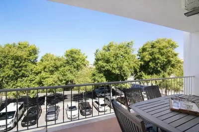 a balcony with a table and chairs and a parking lot at Golden Rana Apartment in Albufeira