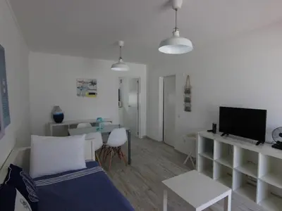 a room with a bed and a desk with a tv at Albufeira Apartments in Albufeira