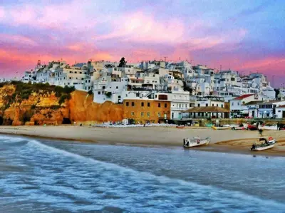 a view of a beach with a group of white houses at Albufeira Apartments in Albufeira