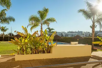 atropical garden with palm trees and a pool at Marina Vilamoura - Aquamar 003 By Vilamoura Sun in Vilamoura