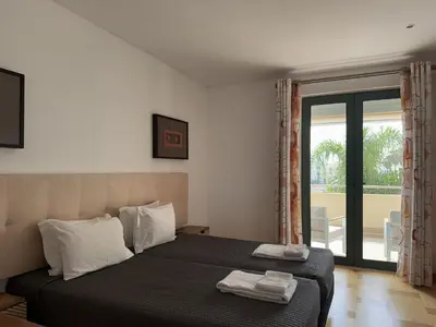 a bedroom with a bed with two towels on it at Marina Vilamoura - Aquamar 209 - By Vilamoura Sun in Vilamoura