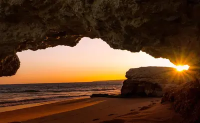 a cave on the beach at sunset at Elegant Villa in Albufeira with Private Pool. in Albufeira