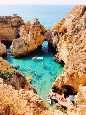 a group of people swimming in a cave in the water at Elegant Villa in Albufeira with Private Pool. in Albufeira