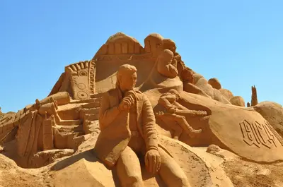 a sand sculpture of a man on a beach at Elegant Villa in Albufeira with Private Pool. in Albufeira