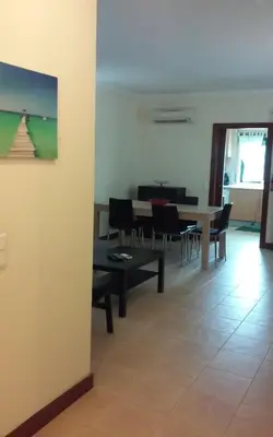 a dining room with a table and chairs at Salgados Village T1 in Albufeira