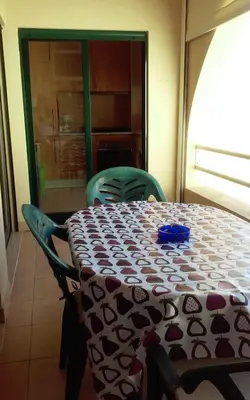 a table and chairs in a room with a tablecloth on it at Salgados Village T1 in Albufeira