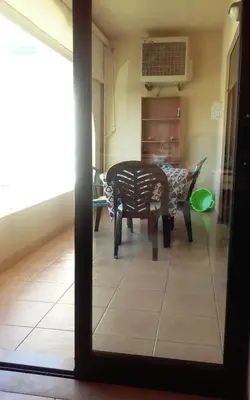 a dining room with a table and a chair at Salgados Village T1 in Albufeira