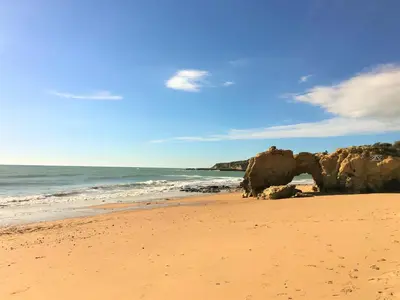 a sandy beach with rocks and the ocean at Excelente T1 Oura Beach Bicos Apartment Lucia in Albufeira