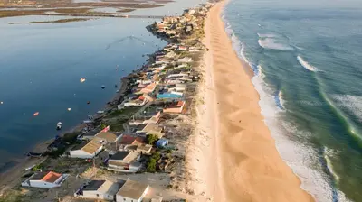 an aerial view of a beach with houses and the ocean at The Market Square House in Faro