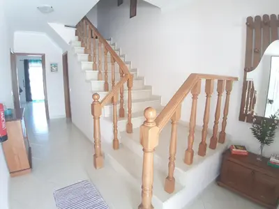 a staircase in a home with wooden railings at Casa Sol da Falesia in Albufeira