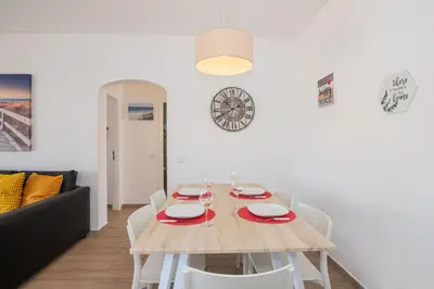a dining room with a wooden table and chairs at Beti Oura Village in Albufeira