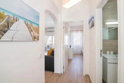 a hallway with a painting of a pier at Beti Oura Village in Albufeira
