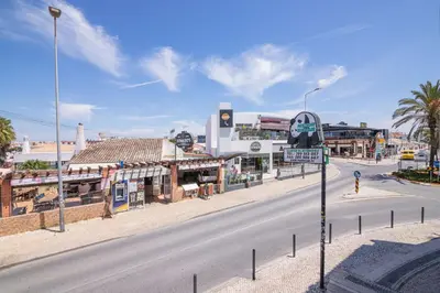 an empty street in a city with a traffic light at Beti Oura Village in Albufeira