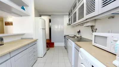 a kitchen with white cabinets and a sink at Palmeiras do Golfe 160 - Clever Details in Vilamoura