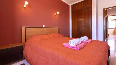 a bedroom with a bed with pink towels on it at ★ Sea View ★ 1 Minute to Oldtown and Beach ★ in Albufeira