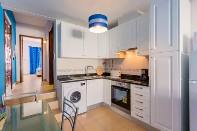 a kitchen with white cabinets and a sink and a dishwasher at ★ Sea View ★ 1 Minute to Oldtown and Beach ★ in Albufeira