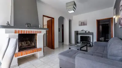 a living room with a couch and a fireplace at ★ Sea View ★ 1 Minute to Oldtown and Beach ★ in Albufeira