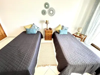 two beds sitting next to each other in a bedroom at Atlântico View - Beach front - Quarteira in Quarteira