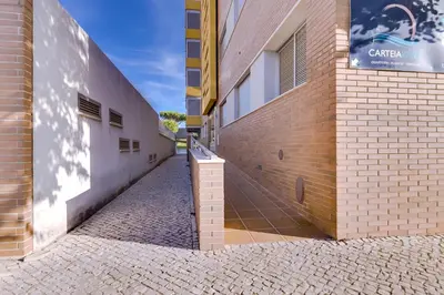 an empty alley next to a brick building at Forte Novo - Modern apartment - Quarteira in Quarteira