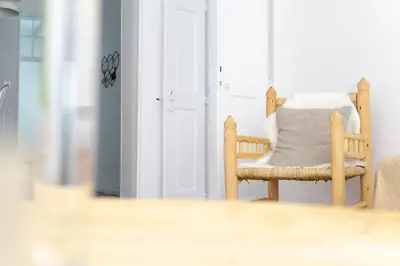 a chair with a pillow on it in a room at Old Charming House Faro in Faro
