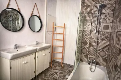 a bathroom with a sink and a shower and a mirror at Old Charming House Faro in Faro