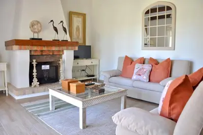 a kitchen with white cabinets and a sink and a window at Fantastic for Family Gatherings, Optional Pool Heating, Free Air Con Wifi in Quarteira