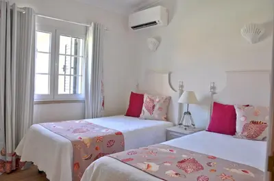 a bathroom with a toilet and a sink and a mirror at Fantastic for Family Gatherings, Optional Pool Heating, Free Air Con Wifi in Quarteira