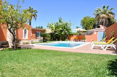 a dining room with a table and chairs at Fantastic for Family Gatherings, Optional Pool Heating, Free Air Con Wifi in Quarteira