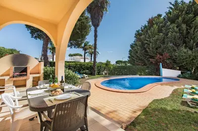 a swimming pool with chaise lounges and palm trees at Exclusive Retreat in Vilamoura, private pool, off-street parking, Free AC wifi in Quarteira