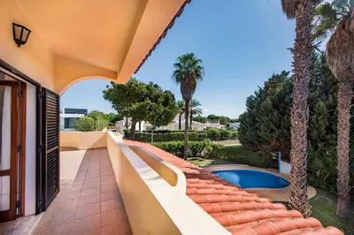 a table and chairs on a patio with a pool at Exclusive Retreat in Vilamoura, private pool, off-street parking, Free AC wifi in Quarteira
