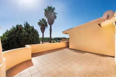 a patio with a table and chairs next to a swimming pool at Exclusive Retreat in Vilamoura, private pool, off-street parking, Free AC wifi in Quarteira