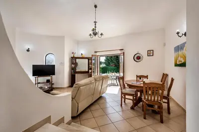 a house with a fence and trees at Exclusive Retreat in Vilamoura, private pool, off-street parking, Free AC wifi in Quarteira