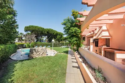 a swimming pool with a rock wall next to a pool at 5 En-Suite Bedrooms, close to centre, free AC WiFi in Loulé