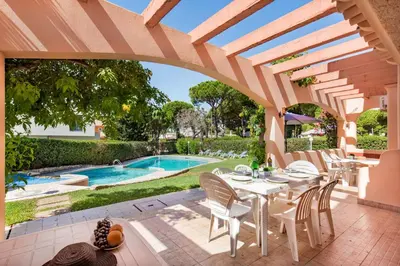 a swimming pool in a yard with lounge chairs at 5 En-Suite Bedrooms, close to centre, free AC WiFi in Loulé