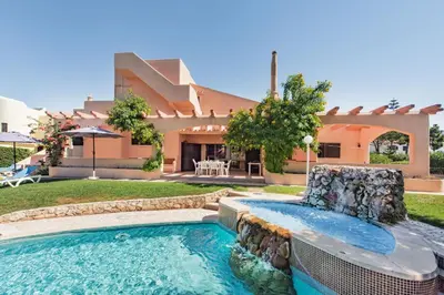 a large kitchen with a counter and stools in it at 5 En-Suite Bedrooms, close to centre, free AC WiFi in Loulé
