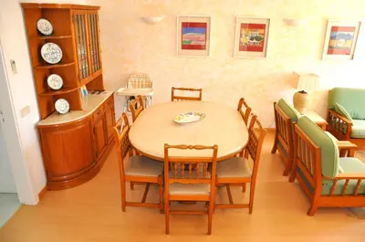 a patio with a table and chairs and a lighthouse at Stylish and well-equipped, private pool, close to amenities, free AC and Wifi in Quarteira