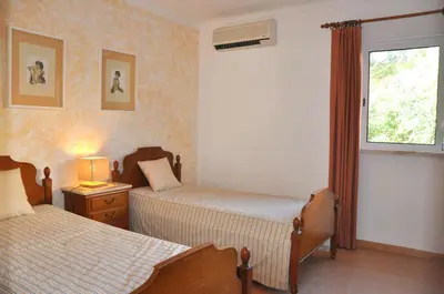 a dining room with a table and chairs at Stylish and well-equipped, private pool, close to amenities, free AC and Wifi in Quarteira