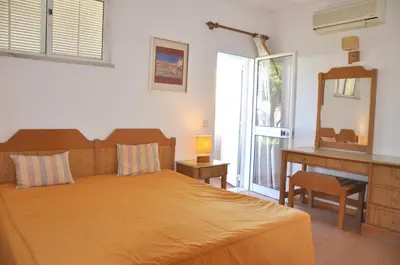a bathroom with a toilet and a sink at Stylish and well-equipped, private pool, close to amenities, free AC and Wifi in Quarteira