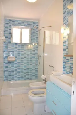 a bedroom with a bed and a chair in a room at Stylish and well-equipped, private pool, close to amenities, free AC and Wifi in Quarteira