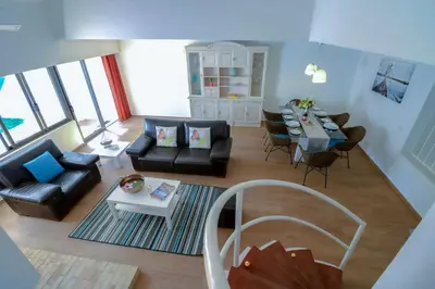 a living room with a couch and a table at Casa Moura Golfe in Vilamoura