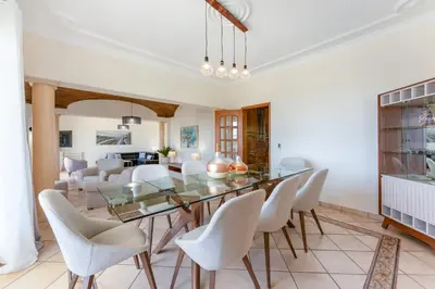 a dining room with a glass table and white chairs at Quinta das Laranjeiras in Boliqueime