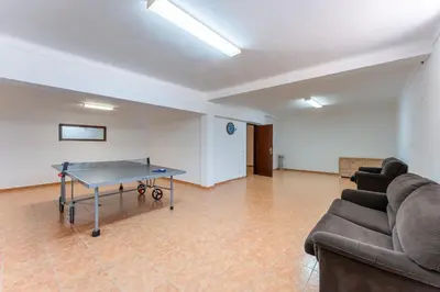 a living room with a ping pong table in it at Quinta das Laranjeiras in Boliqueime
