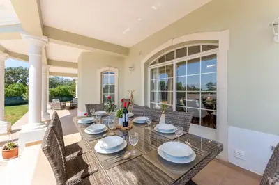 a dining room with a table and chairs at Quinta das Laranjeiras in Boliqueime