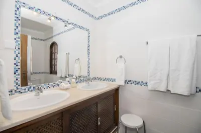 a bathroom with a sink and a mirror at Villa Magali in Galé