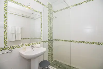 a bathroom with a sink and a shower at Villa Magali in Galé