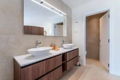 a bathroom with two sinks and a mirror at Villa Natura in Vilamoura