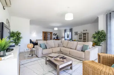 a living room with a couch and a table at Casa Clara in Vilamoura