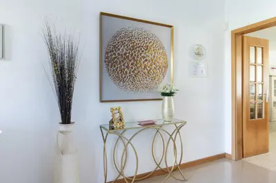 a table in a room with a picture on the wall at Casa Clara in Vilamoura